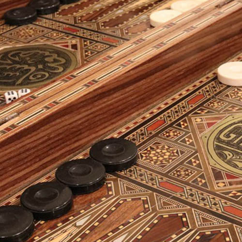 Close-up of a backgammon board with pieces and dice.