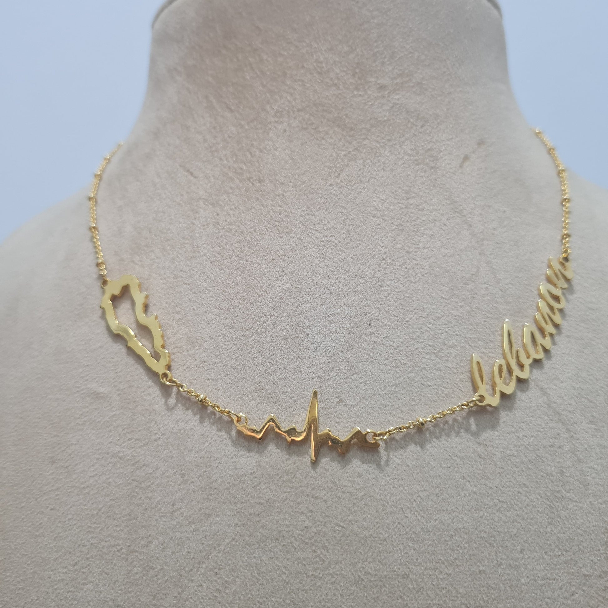 Alt Text: Elegant 18k gold necklace with Lebanon cedar tree design – عقد أنيق من الذهب مرصع برمز شجرة الأرز اللبناني

